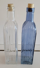 2 DECORATIVE GLASS BOTTLES RIBBED CLEAR AND BLUE 10.25 INCHES HOLDS 18 OZS Decorative Bottle price