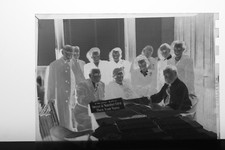 (1) B&W Press Photo Negative Group Portrait Looking Over Table of Papers - T2828 Photo Papers & Acetates price